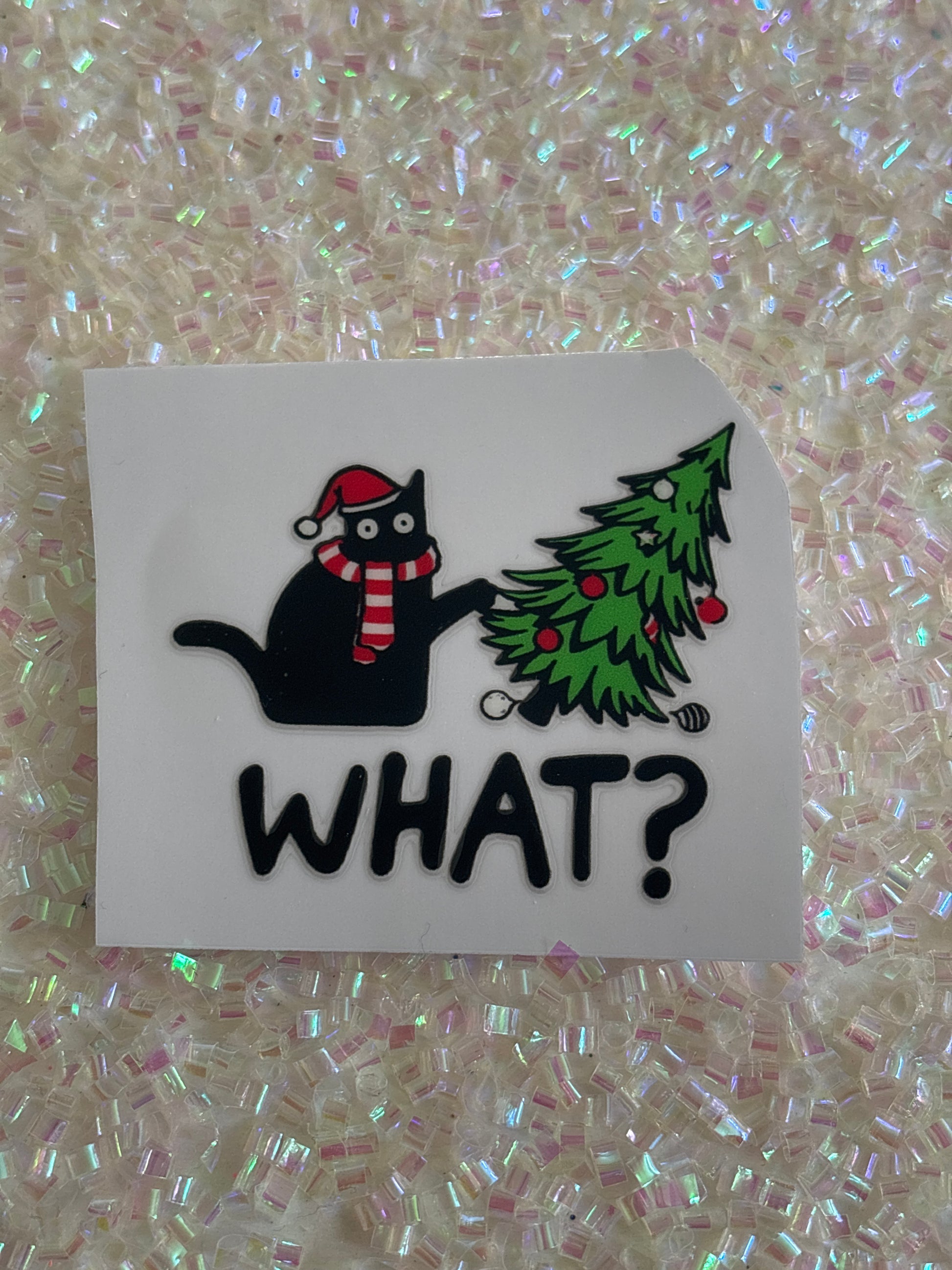 Black cat knocking over Christmas tree