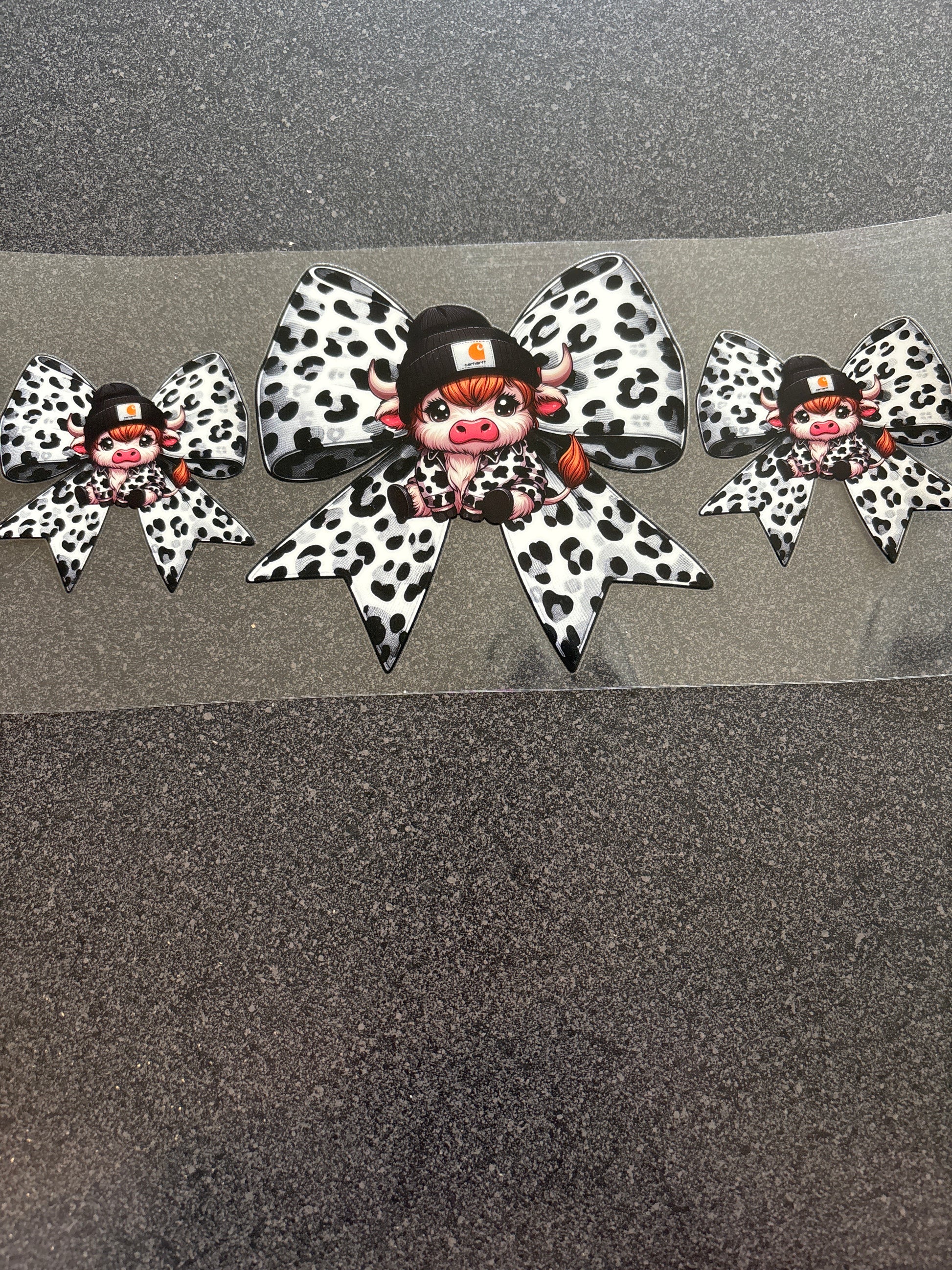 Highland cow with Carhartt hat black and white bows