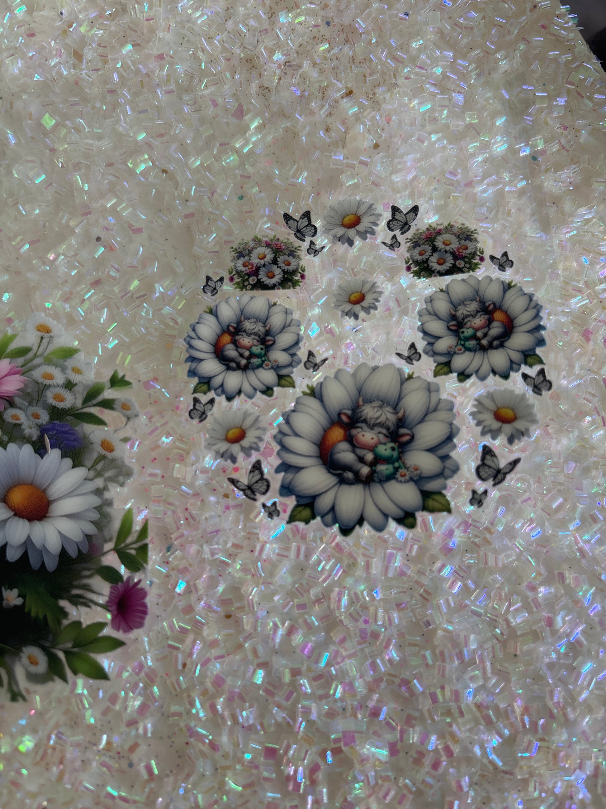 Grey baby Highland cow hugging a dinosaur in a flower with lid decal