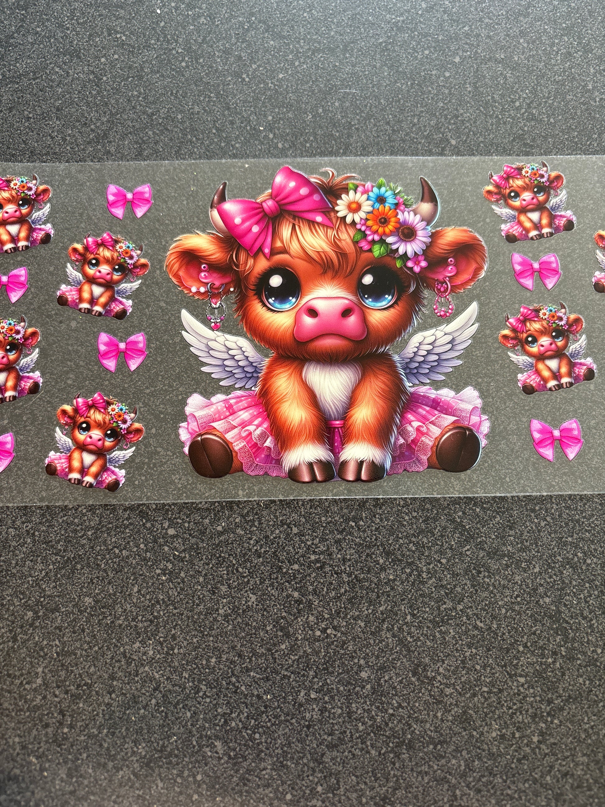 Highland cow with wings and pink bows